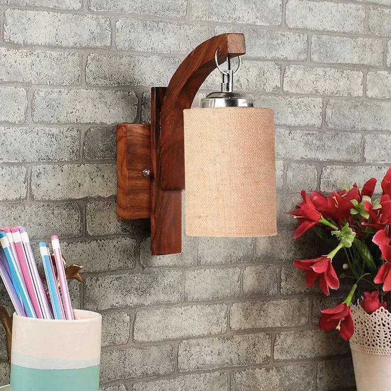 Rustic wooden wall lamp with beige fabric shade mounted on a brick wall