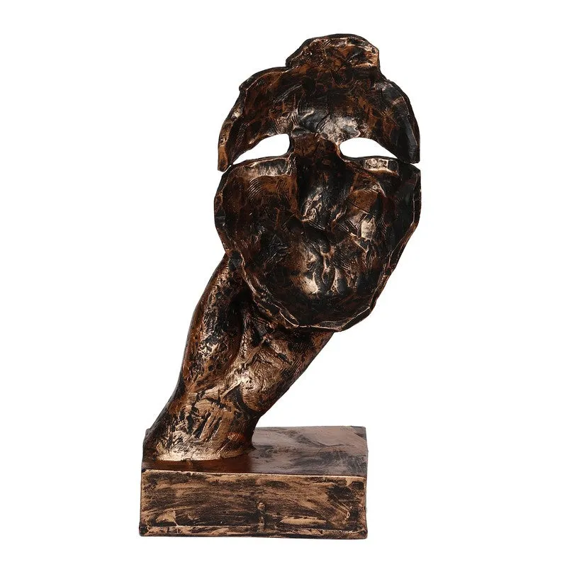Rear view of bronze textured mask showpiece on a rectangular base