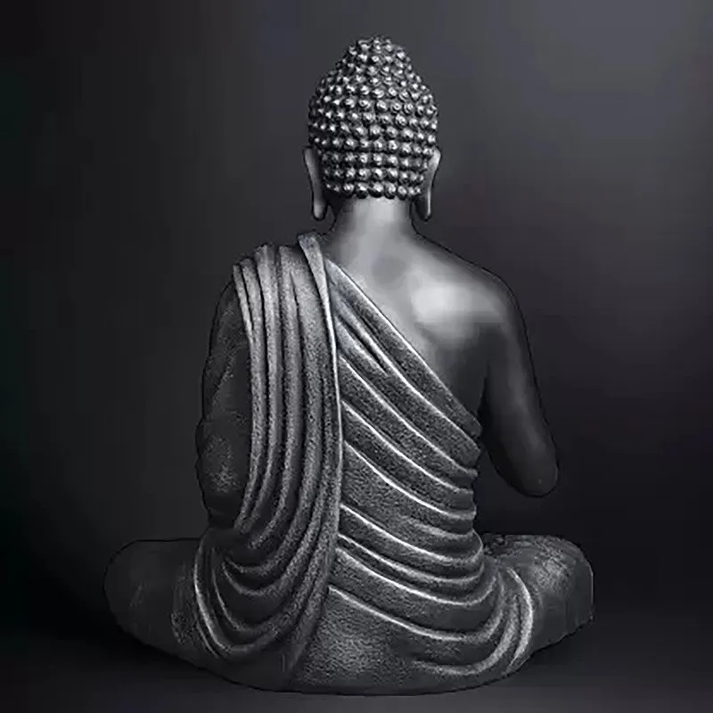 Rear view showing the draped form of a grey seated Buddha idol