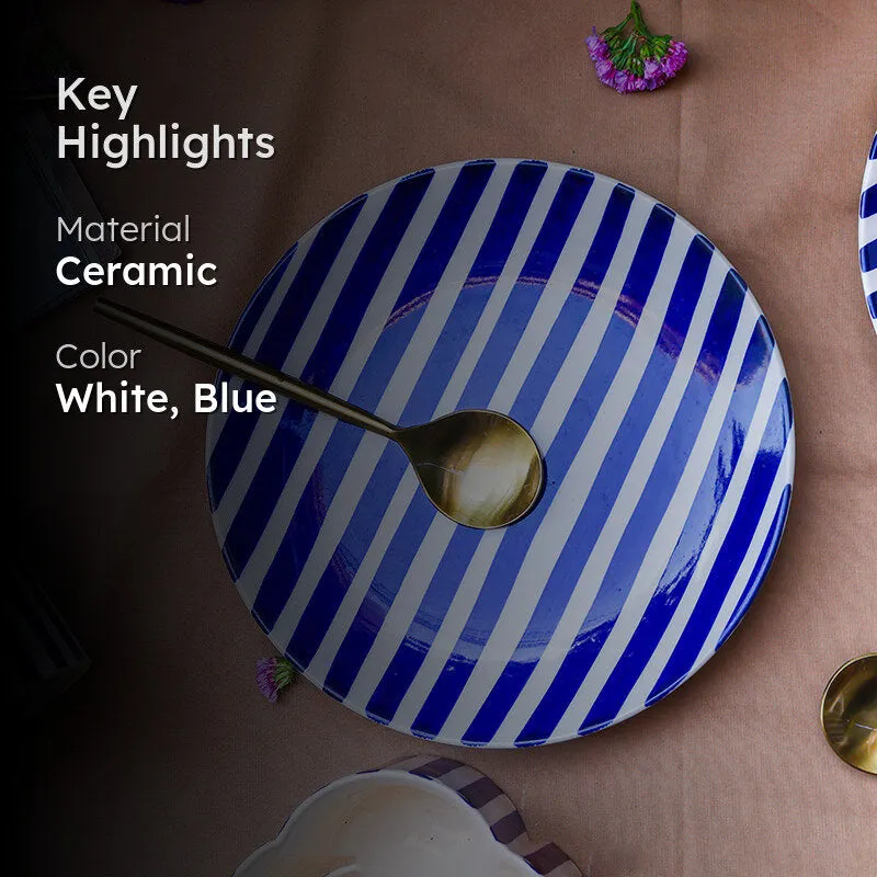 Blue and white striped quarter plate with a spoon on a styled table