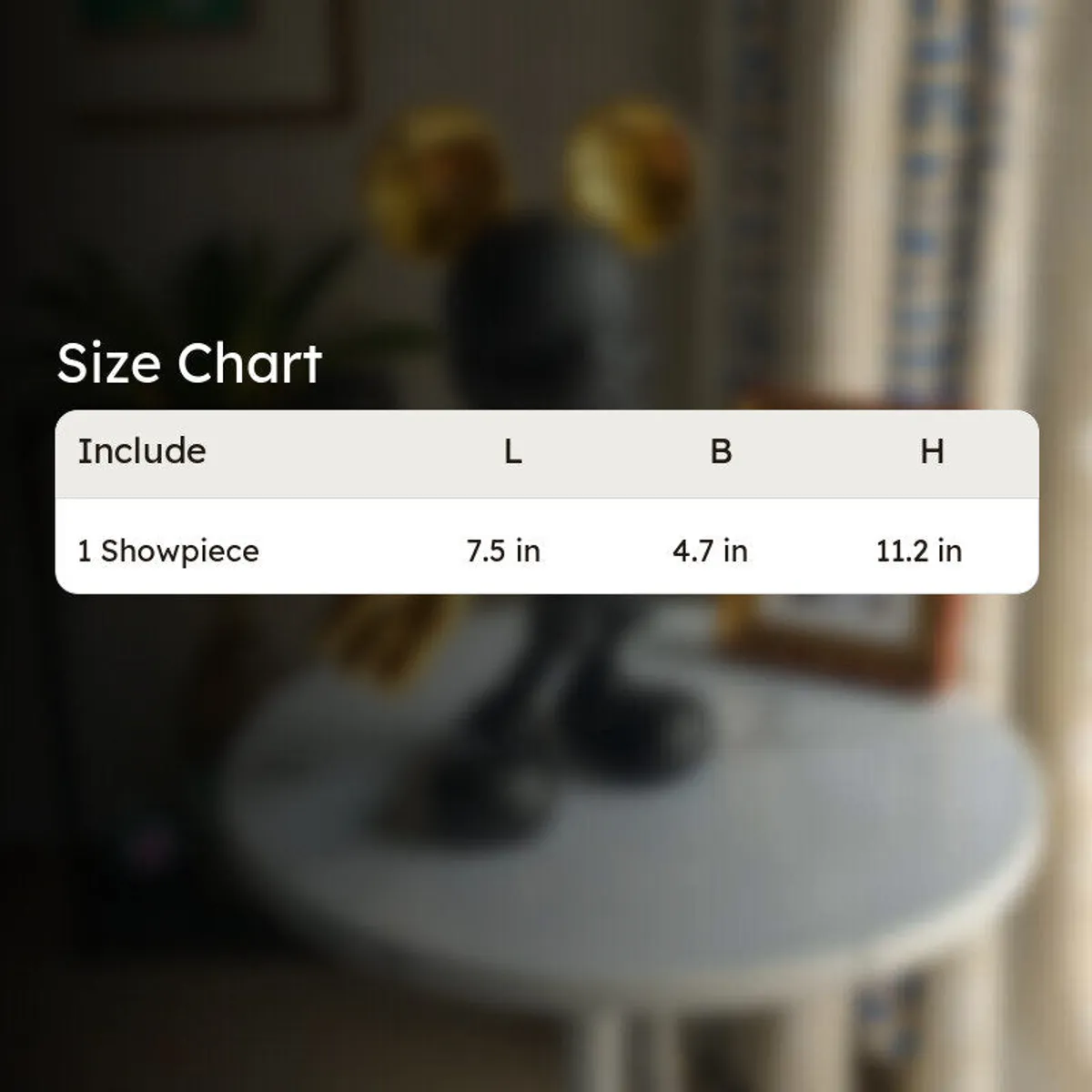 Blurred background image with the black and gold showpiece on a side table
