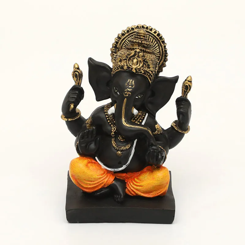 Front view of black and orange Ganesh idol with ornate gold crown