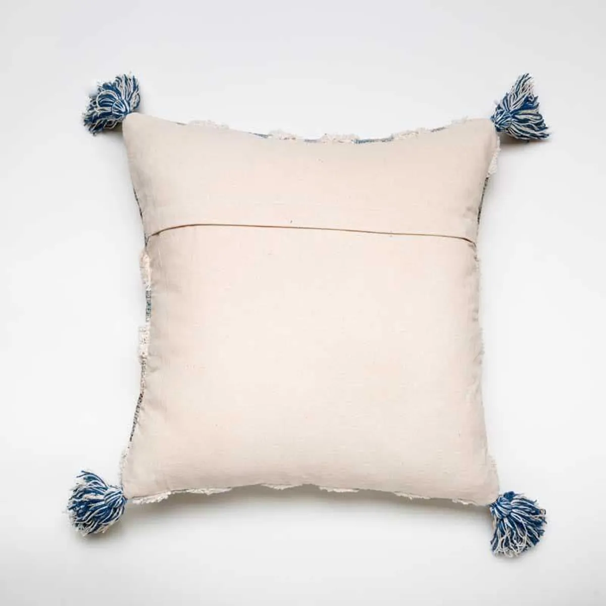 Back view of square cushion cover with four blue tassels