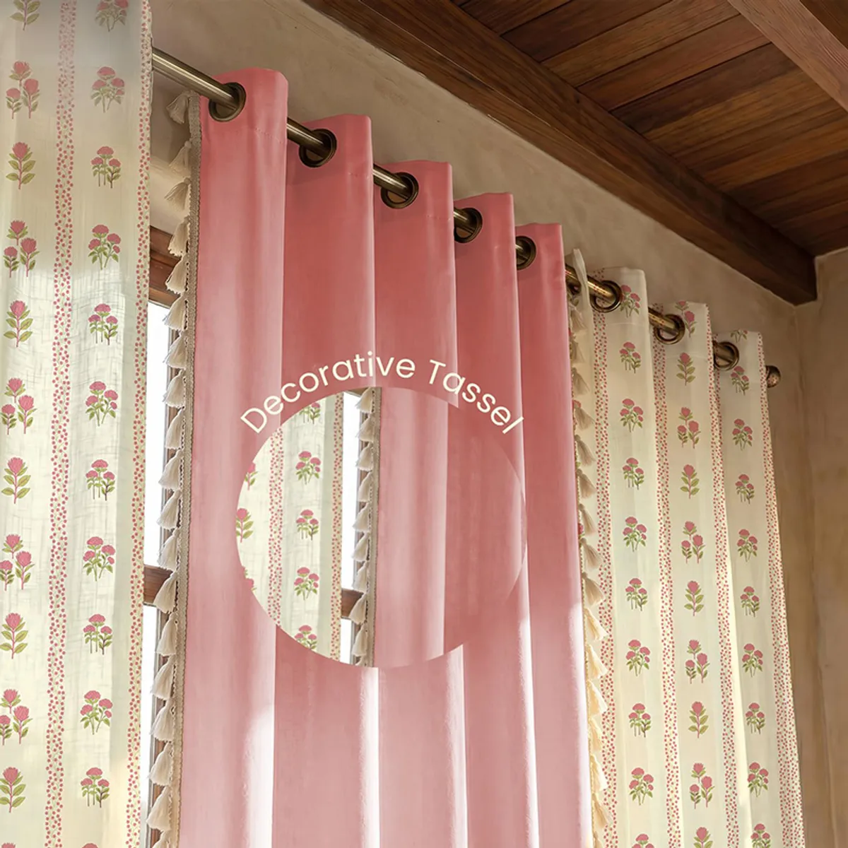 Woman holding the edge of a pink and white floral cotton curtain.