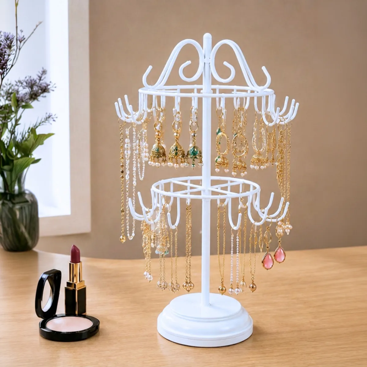 White two-tier jewellery organiser displaying colourful earrings and gold necklaces