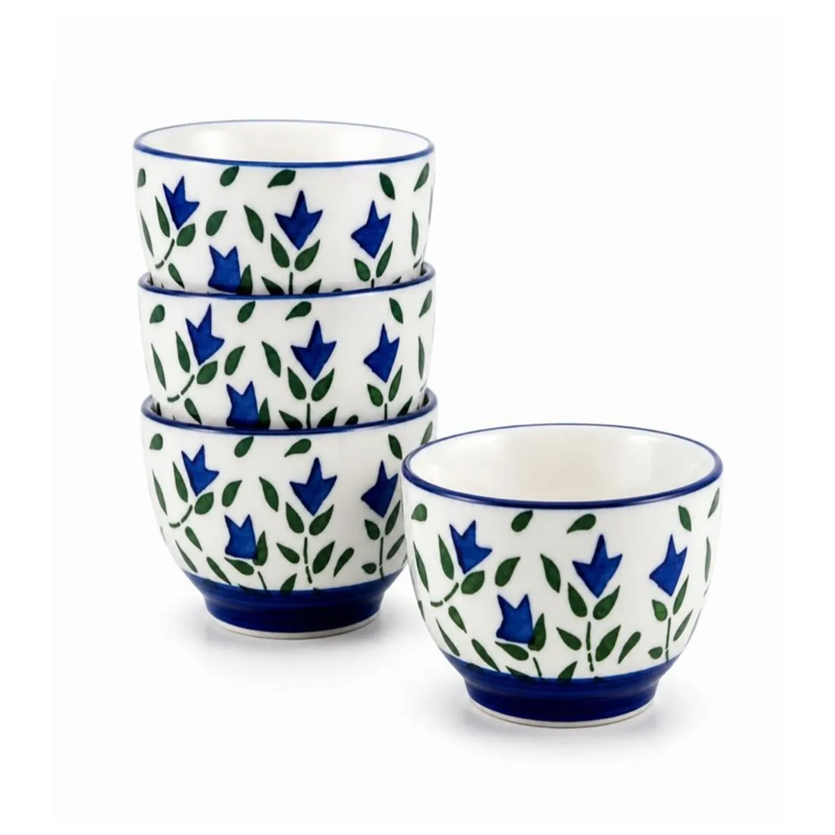 Stack of three blue floral ceramic bowls beside a matching bowl on white background