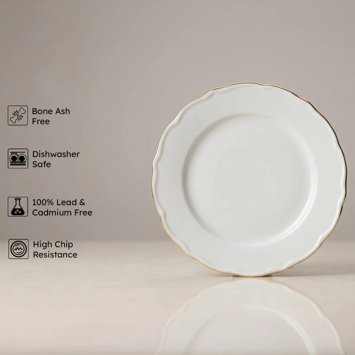 White scalloped plate with gold rim against a neutral background