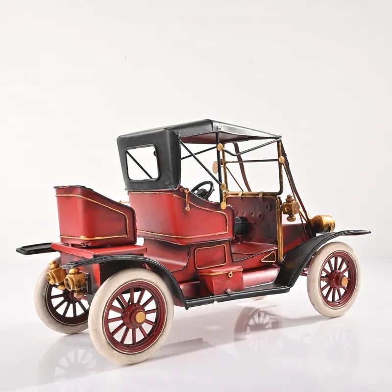 Rear angled view of red vintage car tabletop showpiece on a white background