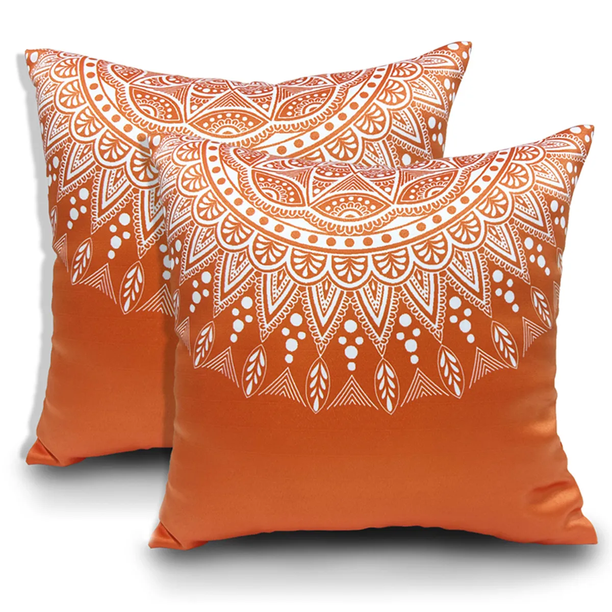 Two orange cushion covers with white geometric mandala prints on a white background