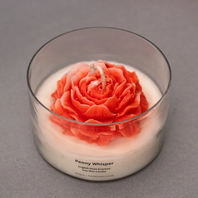 Top view of the red rose-shaped candle set in white wax