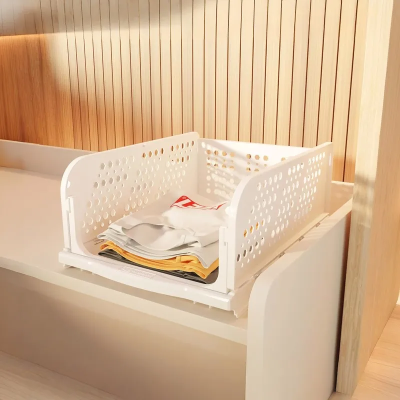 White perforated organiser holding folded clothes inside a wardrobe