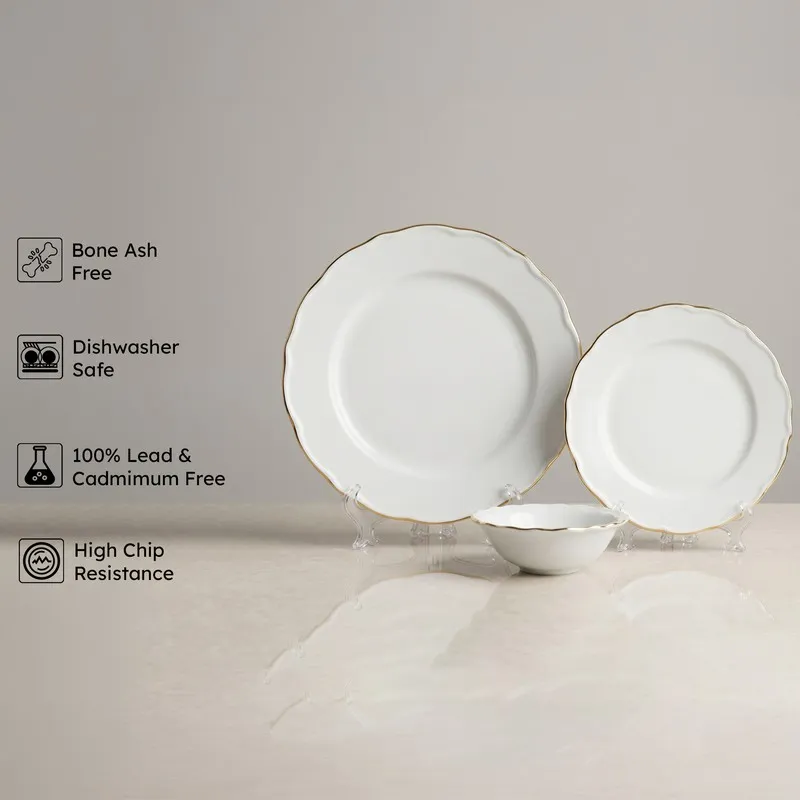 White and gold dinnerware pieces displayed upright on stands