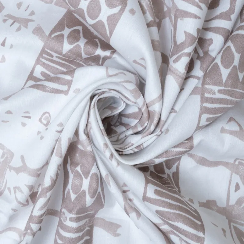 Close-up of white cotton fabric with brown abstract print in a swirled fold
