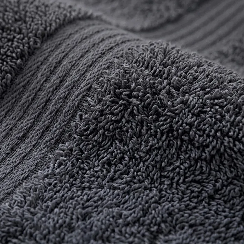 Close-up of the textured charcoal grey cotton towel surface