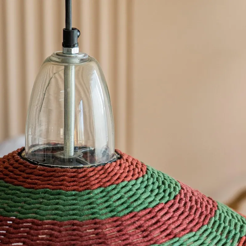 Detail of transparent top fitting and striped red green lamp shade