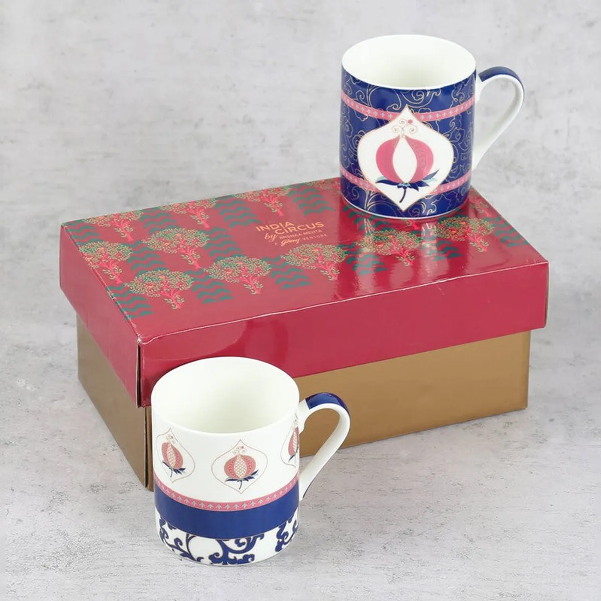 One mug displayed on a patterned gift box beside the other mug