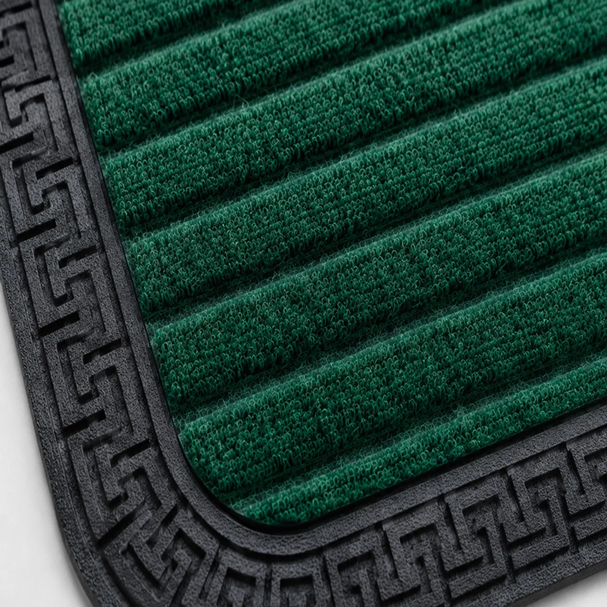 Close-up of the green ribbed mat surface with black patterned rubber border