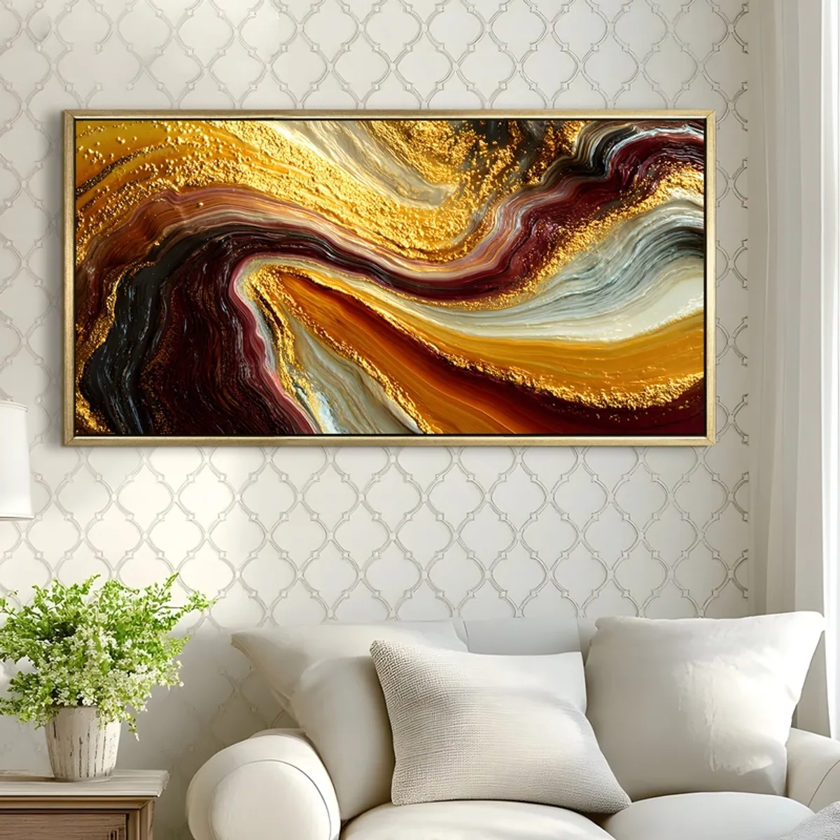 Gold-framed abstract painting displayed above a sofa against patterned wallpaper
