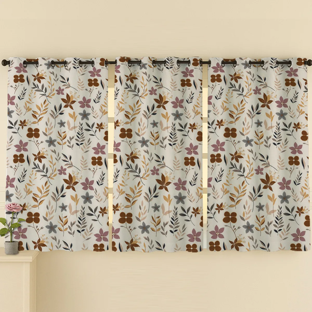 Three floral curtain panels covering a wide window above a cabinet.