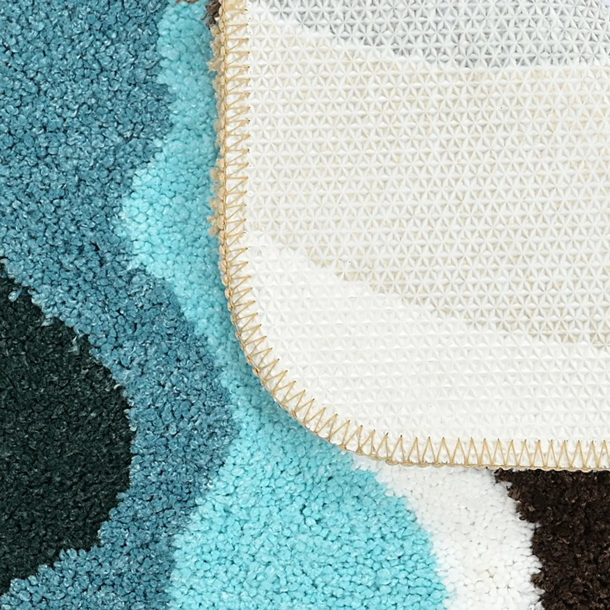 Close-up of bath mat corner showing textured surface and anti-skid backing