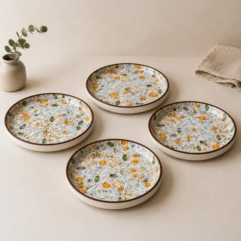 Four round quarter plates with multicolour garden-inspired botanical design