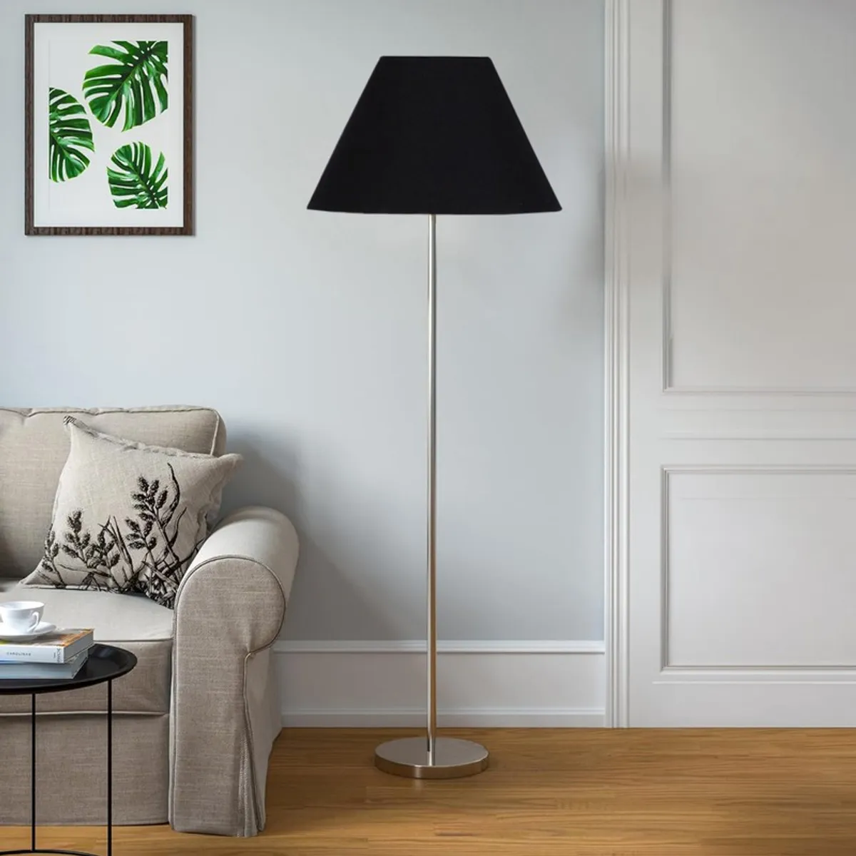 Black floor lamp with conical shade in a bright living room corner