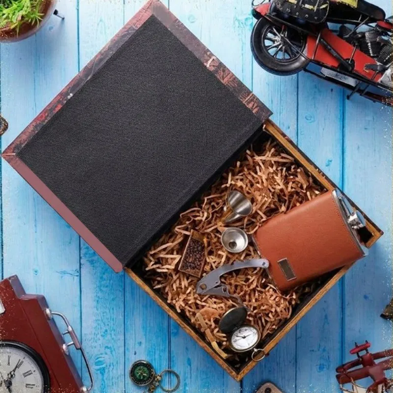 Open storage box filled with travel accessories on a blue wooden surface