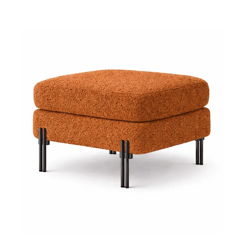Rust square bouclé ottoman with black metal legs on a white background