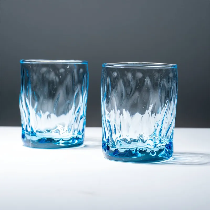 Two ocean blue textured whiskey glasses shown side by side