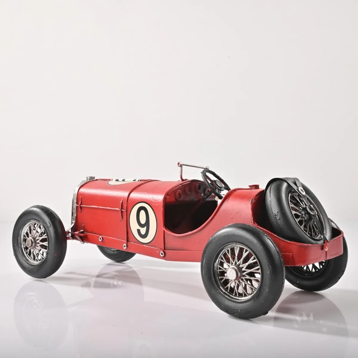 Rear angled view of the red vintage race car showpiece