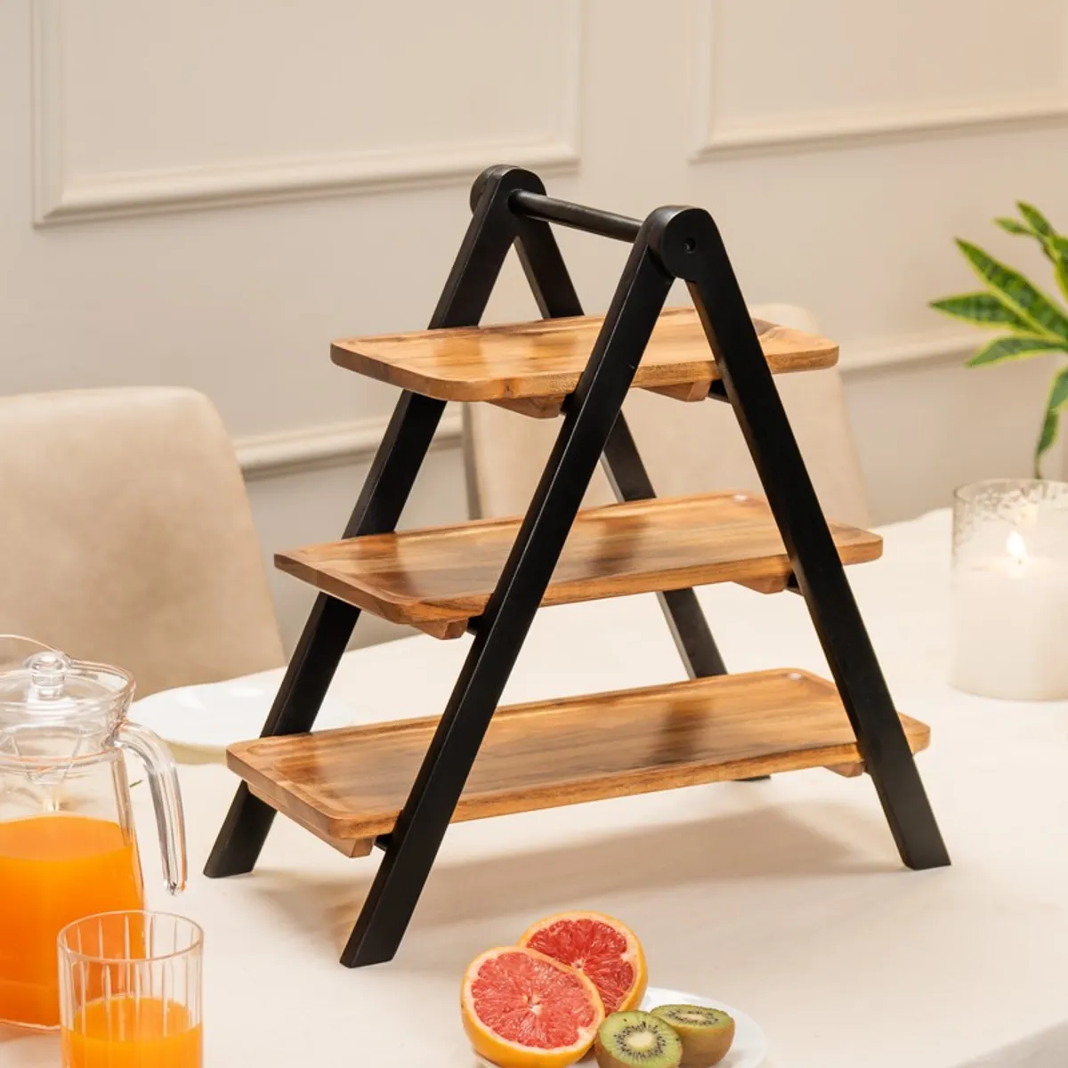 Unfilled three-tier wooden serving stand with black A-frame supports