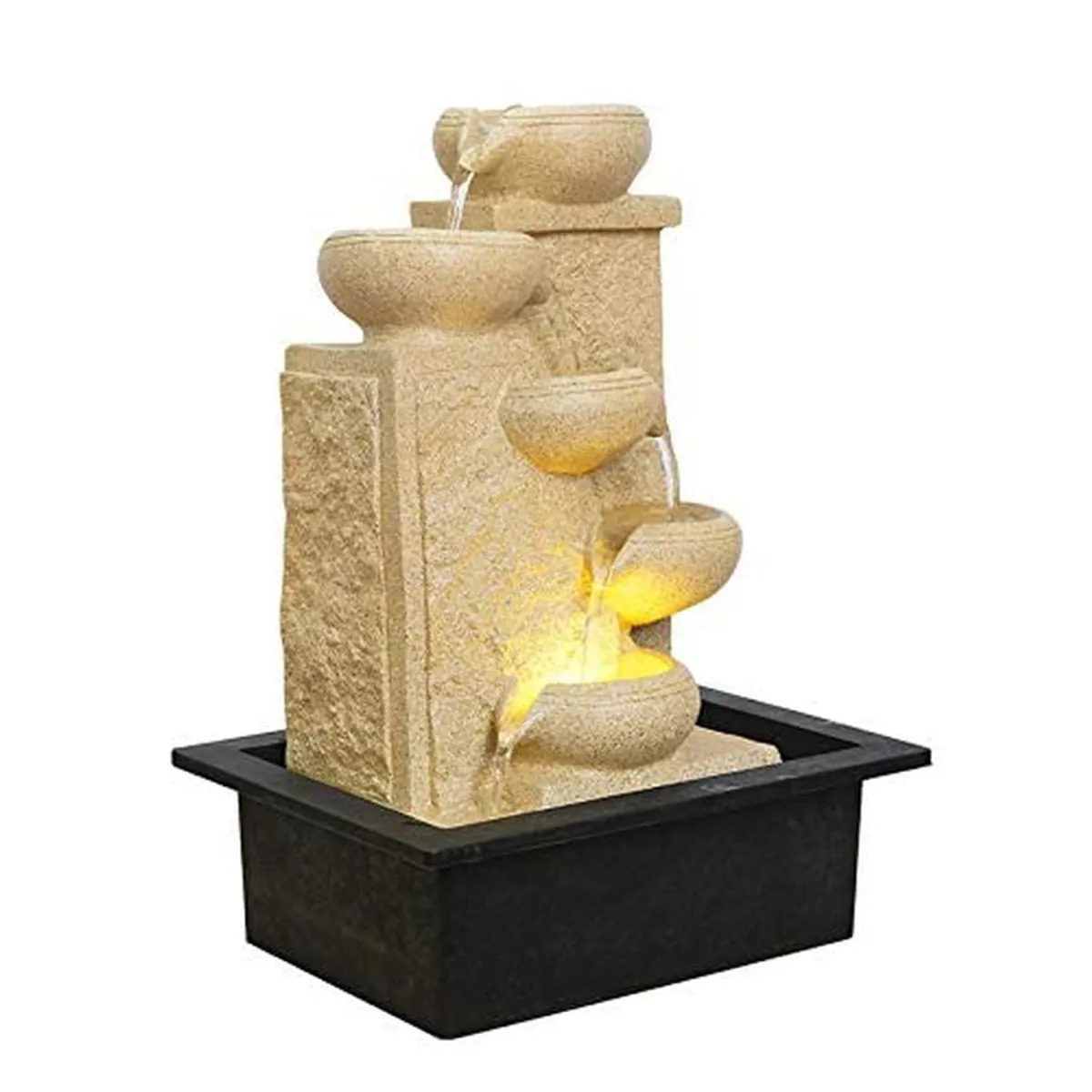 Angled view of an ivory tiered tabletop fountain with warm LED light on a black base
