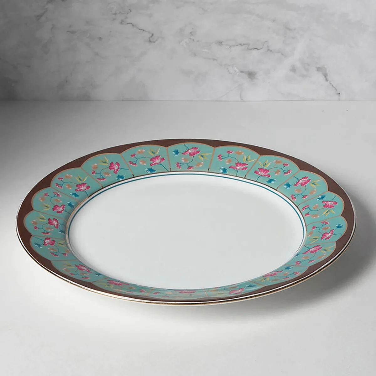 Versailles dinner plate showing a floral border and white centre.