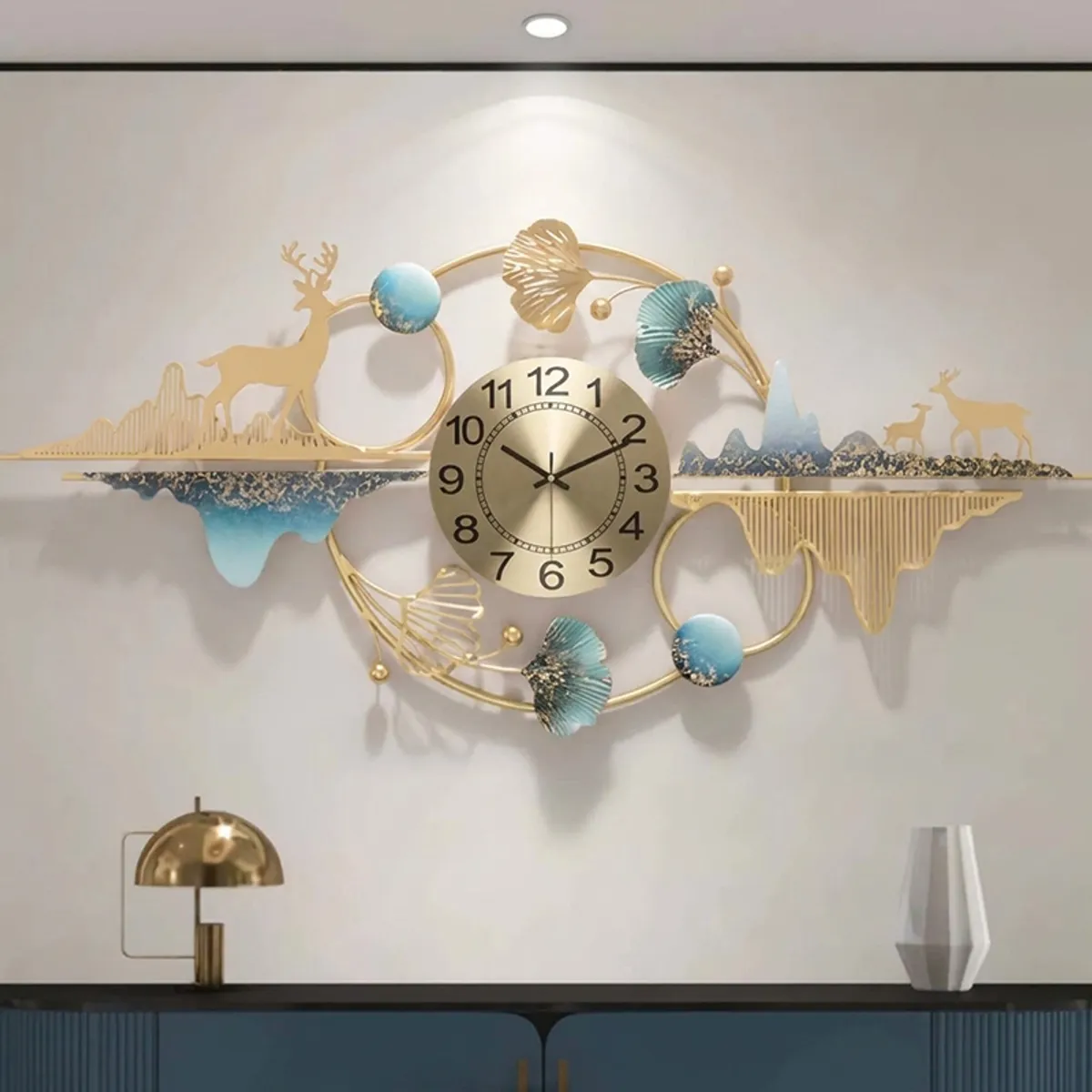Wide decorative metal analog wall clock in gold, blue and white on a styled wall