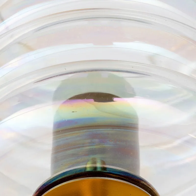 Close-up of iridescent glass shade and metallic base