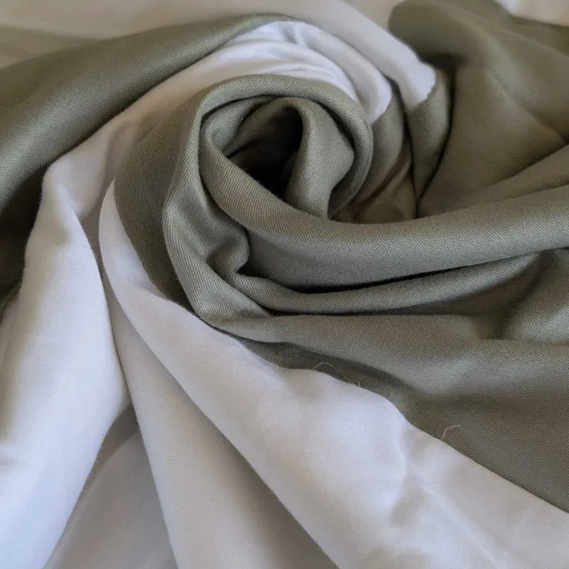 Close-up of green and white cotton fabric folded in a swirl