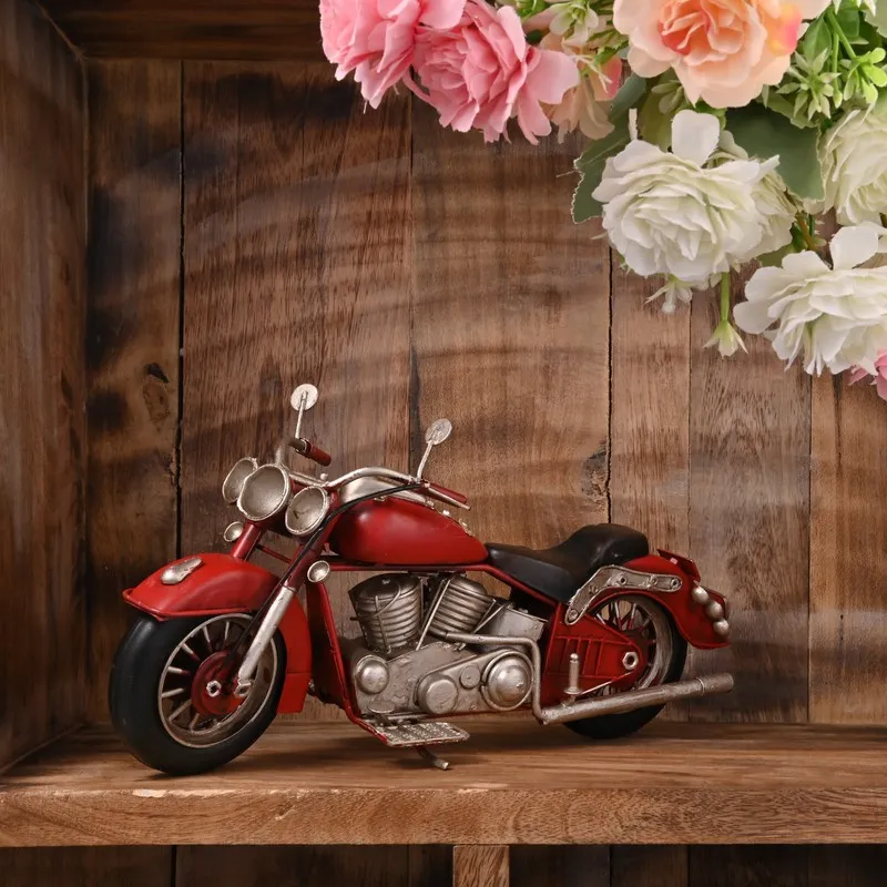 Red motorcycle showpiece displayed on a wooden shelf with flowers