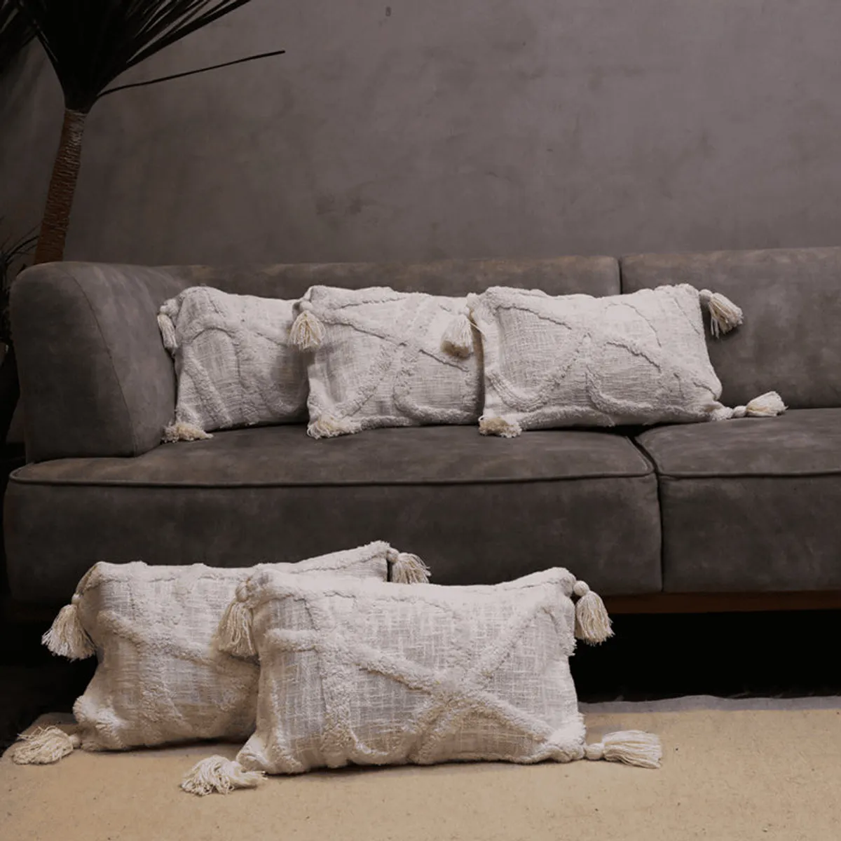Five tufted rectangular cushion covers arranged on a grey sofa