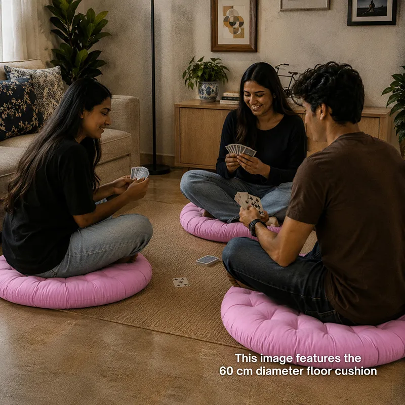 Three people sitting on round lilac floor cushions while playing cards indoors.