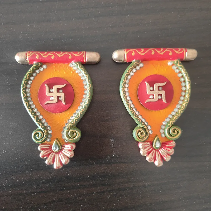 Set of two Sacred Swastik wall accents placed on a dark surface