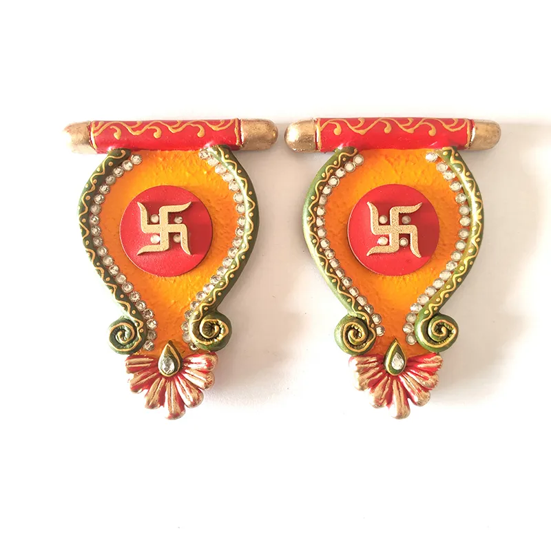 Close-up of two red, orange and green Sacred Swastik wall accents