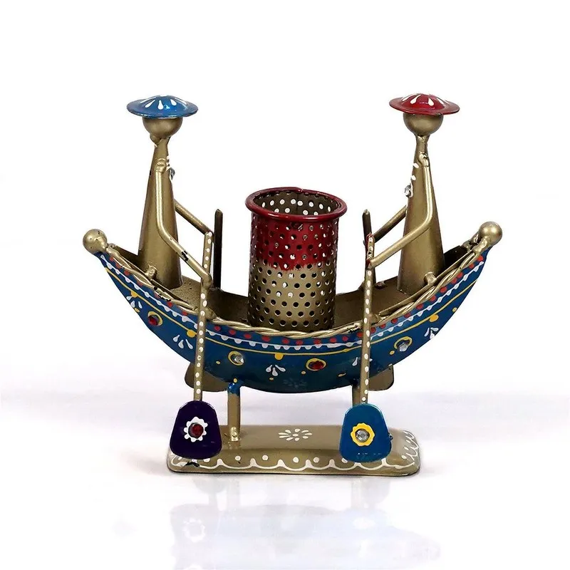 Front view of decorative metal boat pen stand with two figures and central holder