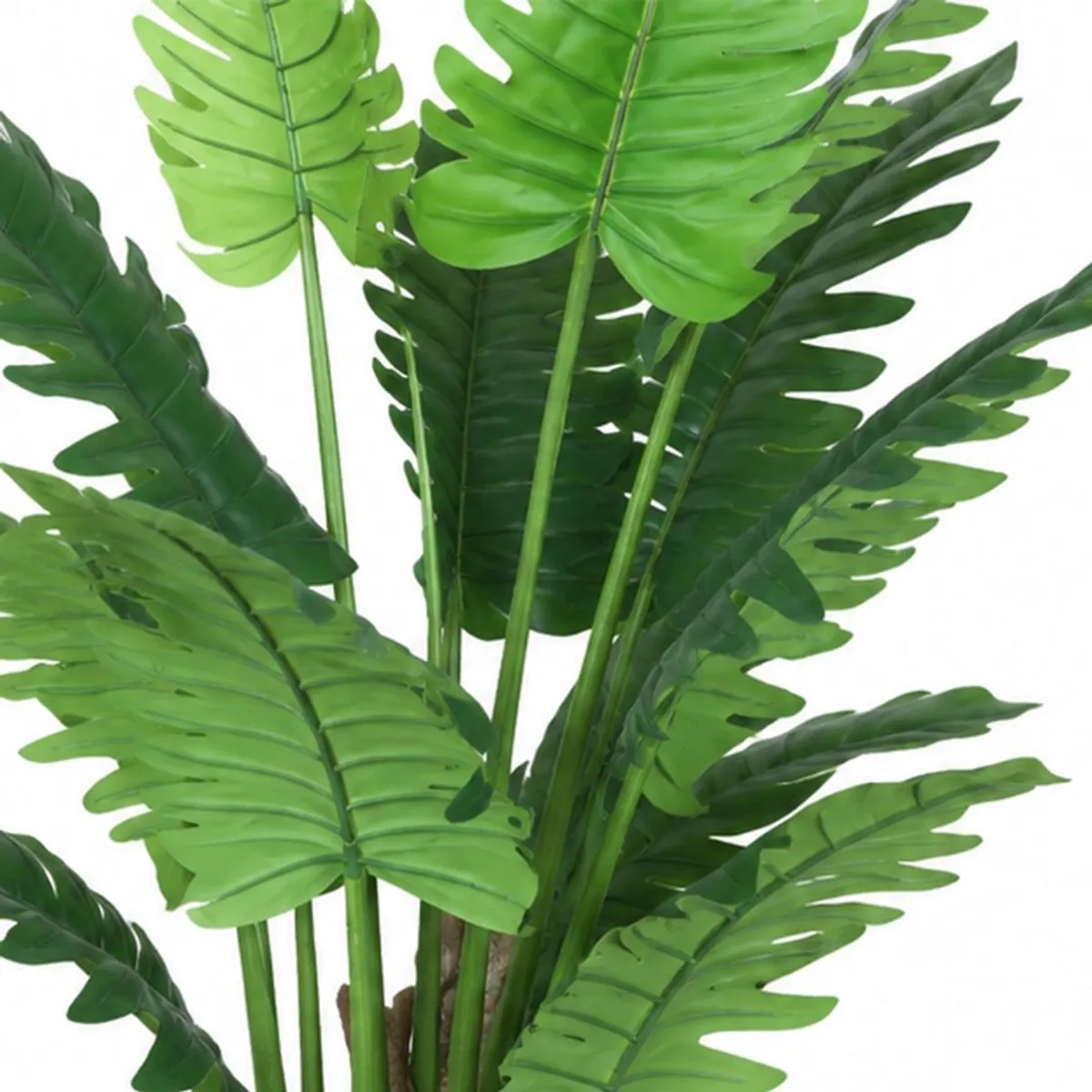 Close-up of large, deeply cut green artificial philodendron leaves and stems