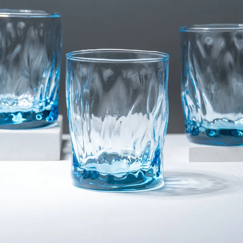 Close-up of a single ocean blue textured whiskey glass