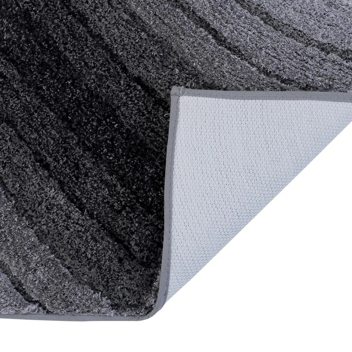Close-up of the bath mat corner showing its anti-slip backing