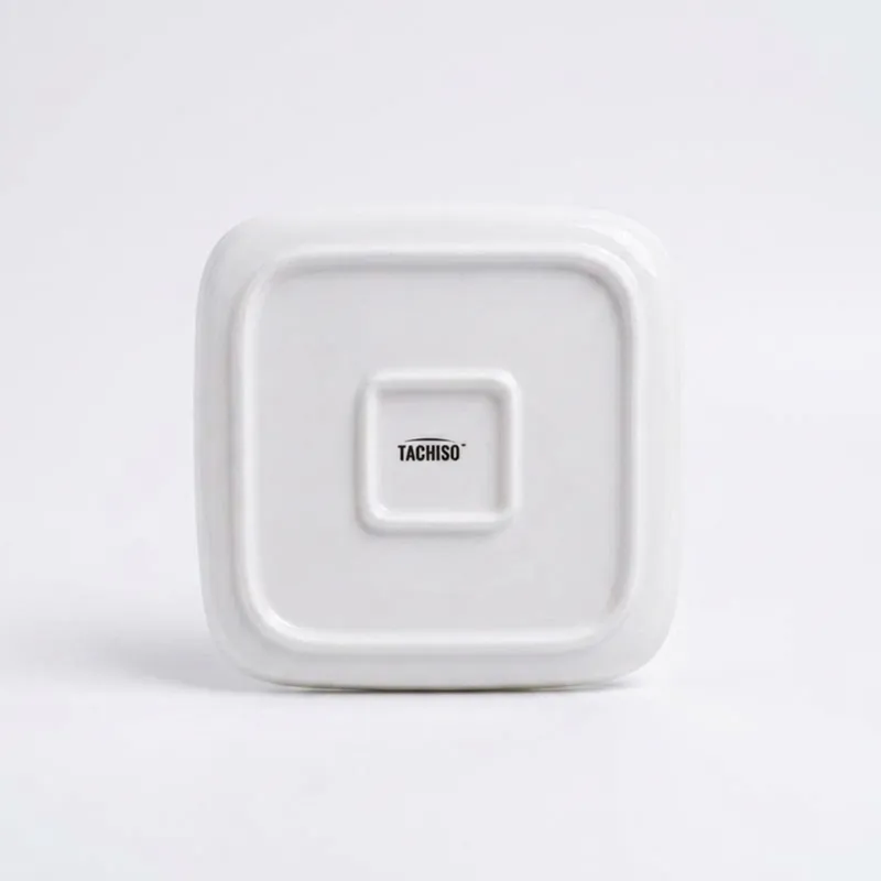 Underside of a square white plate on a plain white background