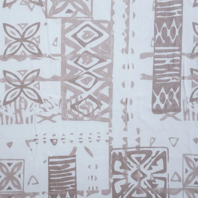 Detailed view of the white bedsheet with brown abstract block-style motifs
