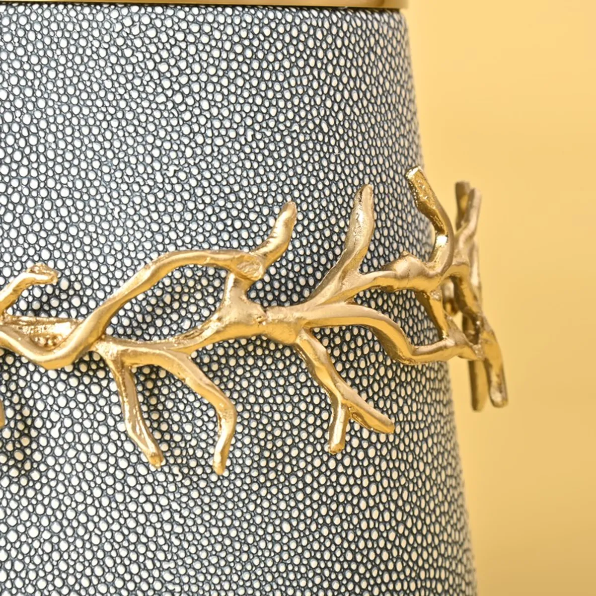 Close-up of the textured blue surface with gold branch detailing