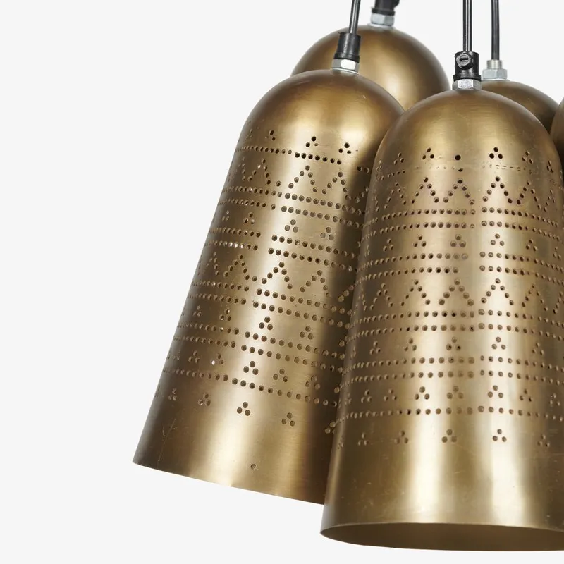 Detailed view of two gold bell-shaped lamp shades in the cluster