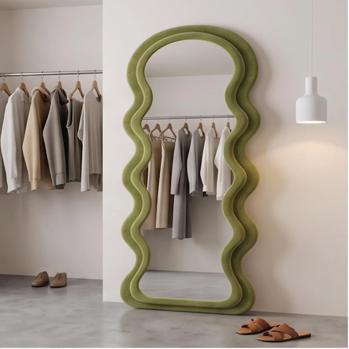 Green full-length ripple mirror placed beside a clothing rail and shoes.